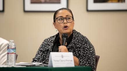 Image of Norma Chavez-Peterson speaking at microphone