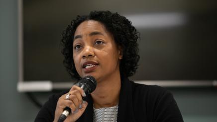Image of Assemblymember Akilah Weber speaking at microphone