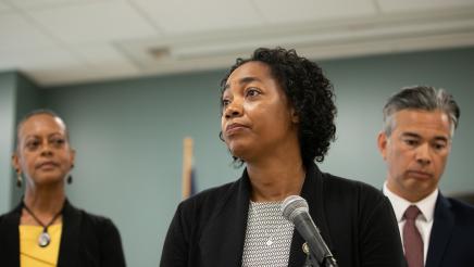 Image of Assemblymember Akilah Weber speaking at microphone.
